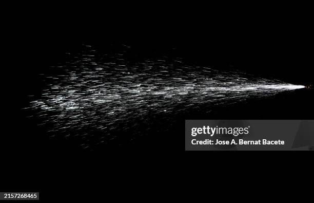 jet of moving pressurized water drops on a black background. - dimma bildbanksfoton och bilder