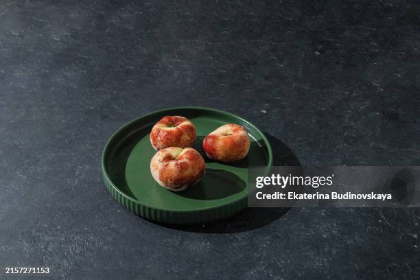 fresh sweet peaches on black table - empty dinner plate stock pictures, royalty-free photos & images