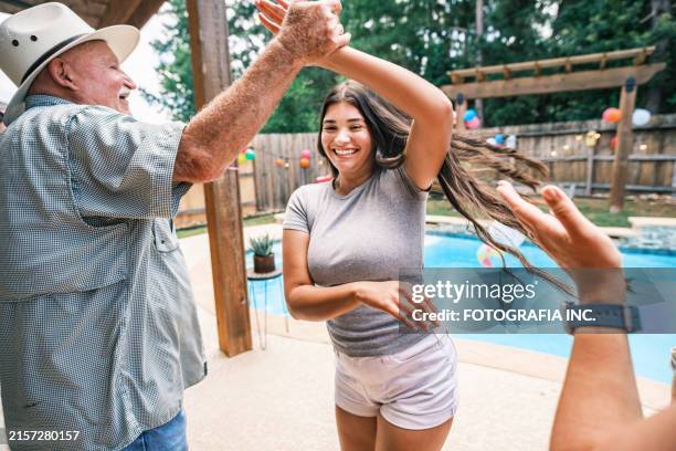 Multi Generation Latino Family Dancing At The Backyard Party High-Res Stock Photo