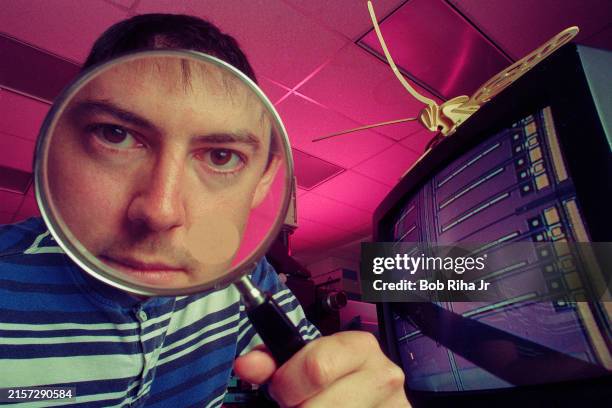 Micro Engineer Kris Pister looks through magnifying glass inside University California Los Angeles Engineering Laboratory where micro structures are...