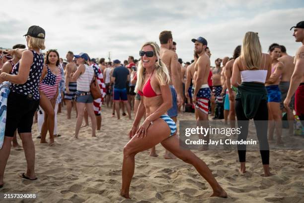 Annie Seawright, a multi-year winner of the competition, stretches before the race begins on July 4 in Hermosa Beach, California. In celebration of...