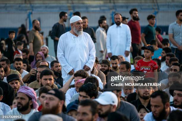 Syrians perform Eid al-Adha prayers in the municipal stadium in Idlib, northwestern Syria, on June 16, 2024. The rebel-held Idlib is home to over...