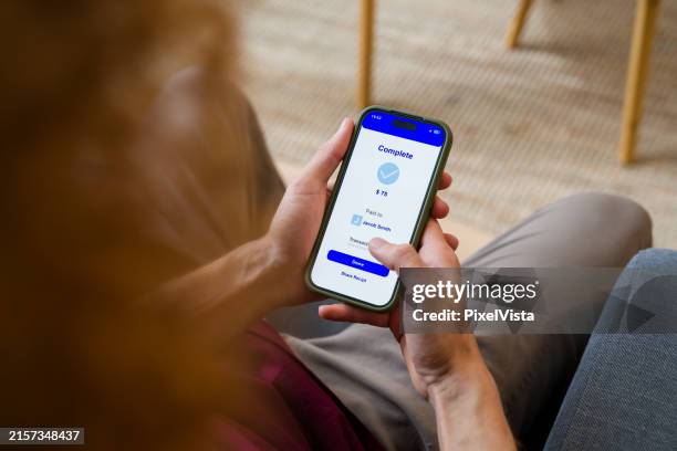 man using mobile banking app on smartphone completing payment - mobile banking stock pictures, royalty-free photos & images