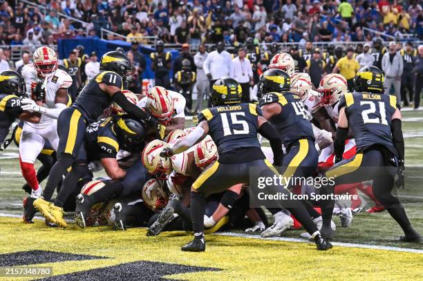 Birmingham Stallions quarterback Adrian Martinez fights through the pile to just get the ball over he goal line for a touchdown during the UFL...