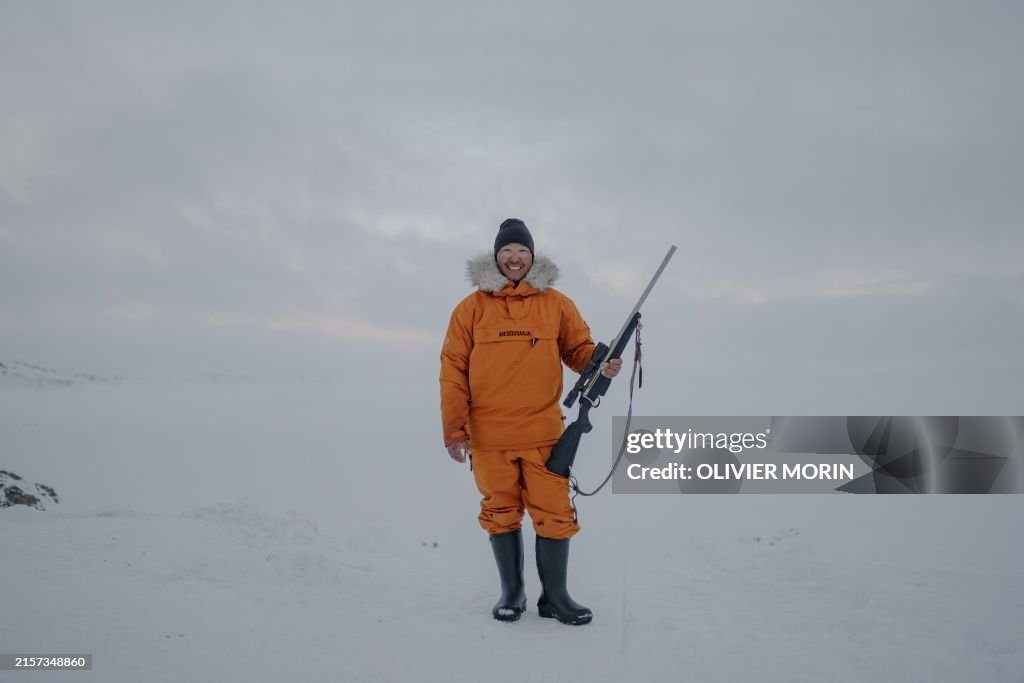 Professional Inuit hunter Martin Madsen poses with a rifle in... News ...