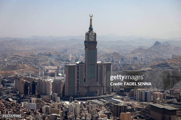 An aerial view shows the Abraj al-Bait also known as the Mecca Royal Hotel Clock Tower Saudi in Arabia's holy city of Mecca on June 17 during the...