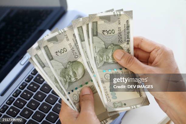 counting indian currency notes,closeup - more customers stock pictures, royalty-free photos & images