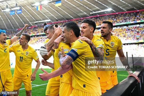 Romania's midfielder Razvan Marin celebrates scoring his team's second goal during the UEFA Euro 2024 Group E football match between Romania and...
