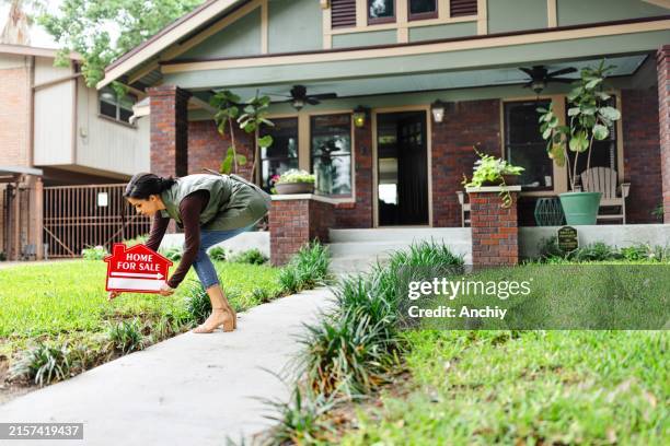 real estate agent preparing a house for sale - for sale sign stock pictures, royalty-free photos & images