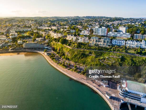sunset over promenade on the coast in torquay - torquay seafront stock pictures, royalty-free photos & images