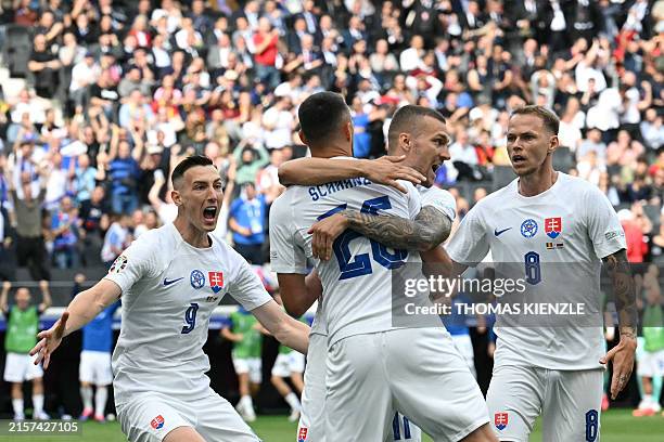 Slovakia's forward Ivan Schranz celebrates with teammates after scoring their first goal during the UEFA Euro 2024 Group E football match between...