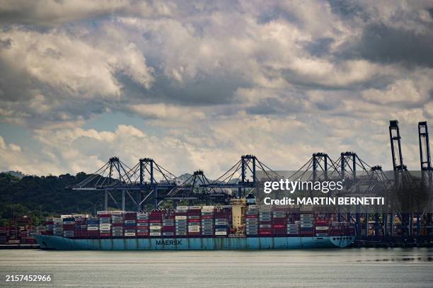 Cranes load a cargo ship at the port of Balboa in Panama City on June 17, 2024. . The Panama Canal will once again increase the number of ships...