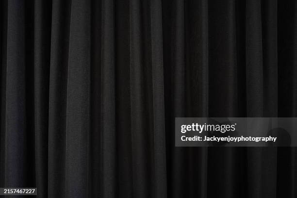 background made of thick cloth from dark grey drapes. background information for all texts. - curtain stock pictures, royalty-free photos & images