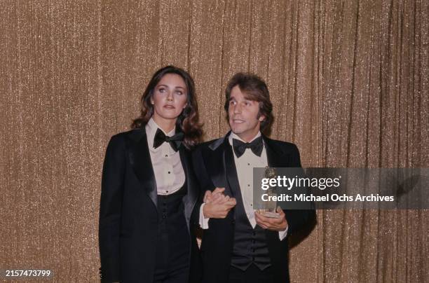 American actress Lynda Carter, wearing a tuxedo and bow tie, and American actor Henry Winkler, who also wears a tuxedo and bow tie, in the 34th...