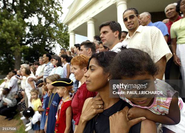 Tiana Norvell , 2yrs, wiggles around on the shoulders of her mother Monica Steed as they pose for a large family photo with about 150 of the...