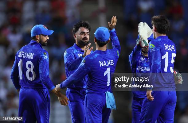 Rashid Khan of Afghanistan celebrates with teammates after running out Chad Soper Papua New Guinea during the ICC Men's T20 Cricket World Cup West...