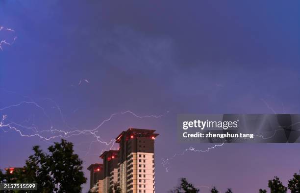 thunderstorm over residential area. - lightning home stock pictures, royalty-free photos & images