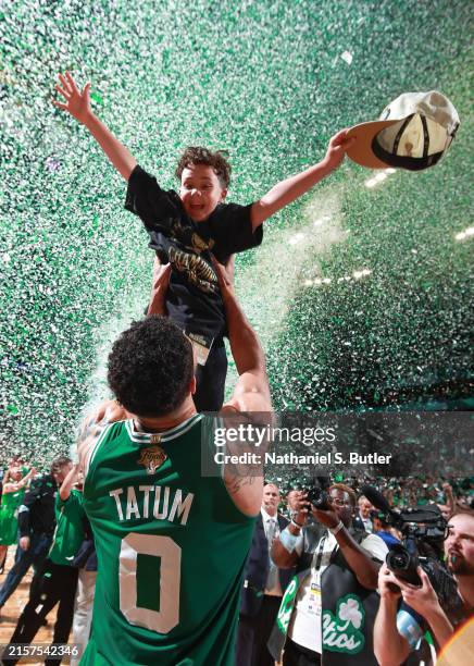 Jayson Tatum of the Boston Celtics celebrates with Deuce Tatum after winning the 2024 NBA Championship against the Dallas Mavericks during Game 5 of...