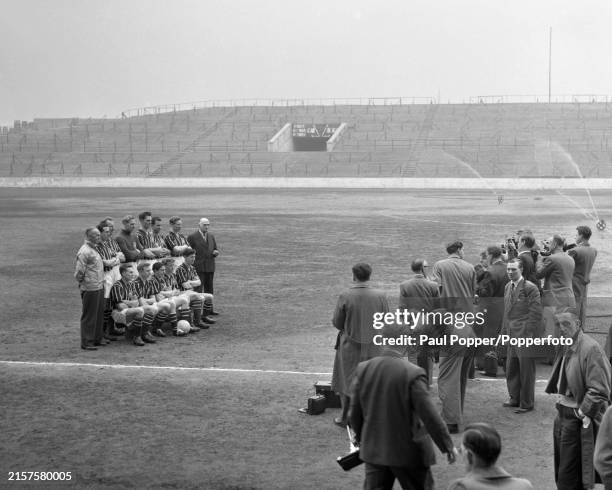 Manchester City line up for a group photo wearing their FA Cup Final shirts in front of the press at Maine Road on April 23, 1956 in Manchester,...