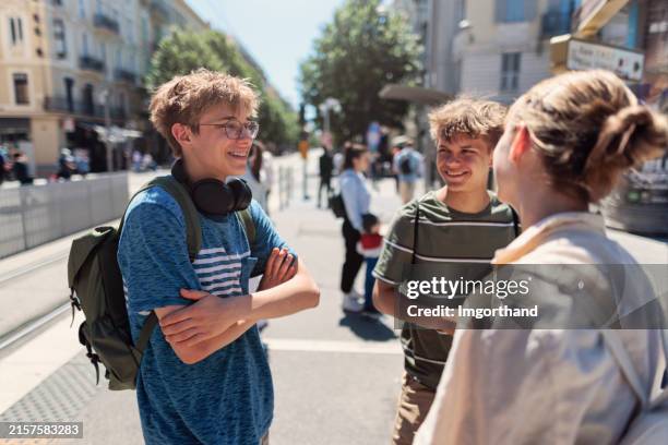 teenager warten auf die straßenbahn in der stadt nizza, frankreich - männlicher teenager stock-fotos und bilder
