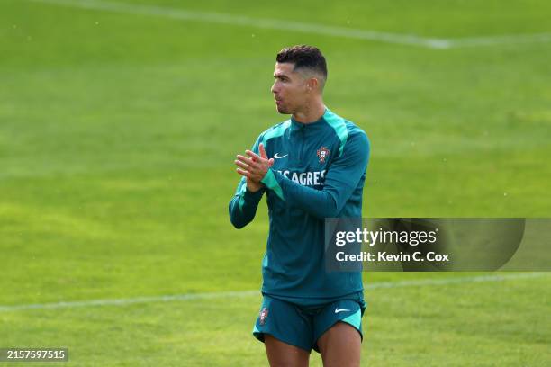 Cristiano Ronaldo of Portugal applauds during the Portugal Public Training Session at Heidewaldstadion on June 14, 2024 in Guetersloh, Germany.