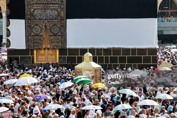 Muslim pilgrims move past Maqam Ibrahim as they perform the farewell circumambulation or "tawaf", circling seven times around the Kaaba, Islam's...