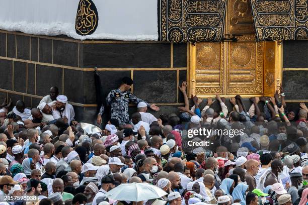Muslim pilgrims perform the farewell circumambulation or "tawaf", circling seven times around the Kaaba, Islam's holiest shrine, at the Grand Mosque...