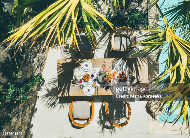 beautifully set outdoor dining table on the pool terrace. - outdoor dining stock pictures, royalty-free photos & images