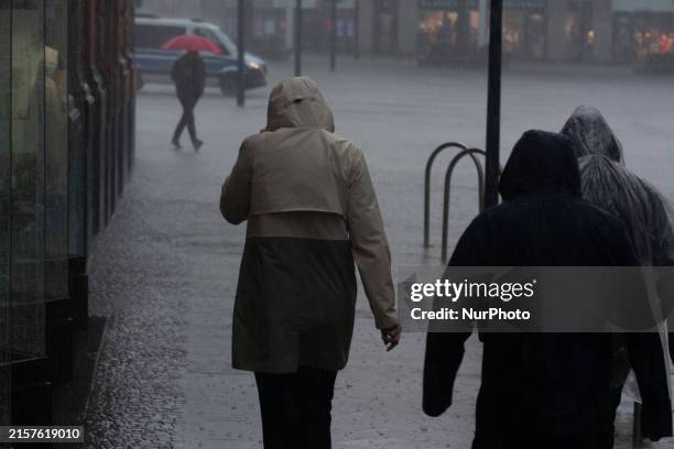 People are struggling to walk during the stormy weather in Dortmund, Germany, on June 18, 2024.