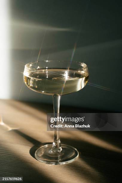 white wine in drinking glass on table in bright sunlight - indoor picnic stock pictures, royalty-free photos & images