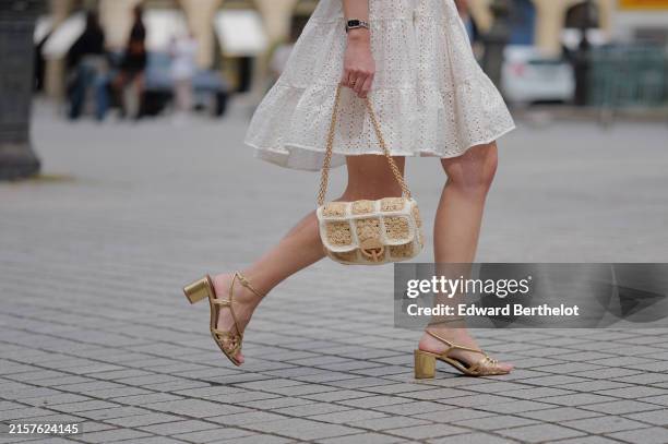 Segolene Hyppolite wears a white mini pleated and gathered summer dress with floral embroidery and long sleeves from Anne Fontaine, a rope belt from...