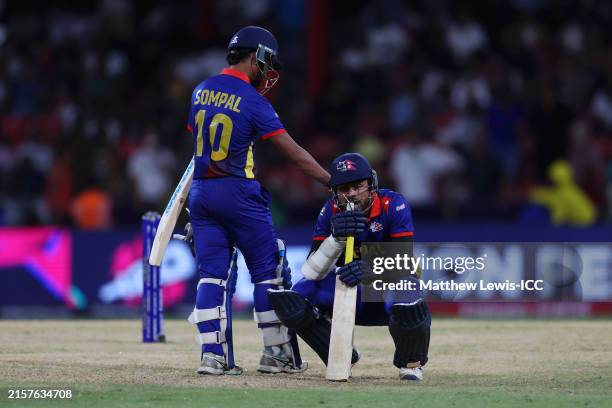 Sompal Kami and Gulshan Jha of Nepal looks dejected after losing the ICC Men's T20 Cricket World Cup West Indies & USA 2024 match between South...