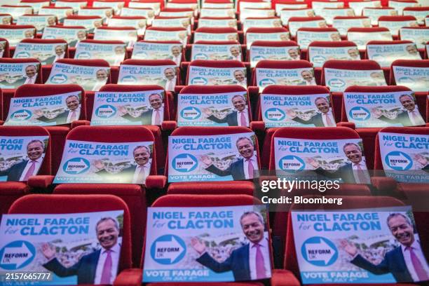 Placards are laid out on seating ahead of Nigel Farage, leader of Reform UK, speaking to local residents during a town hall general election campaign...