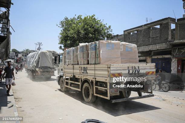 Aid trucks of The United Nations Relief and Works Agency for Palestinian Refugees in the Near East deliver aid to Salah al-Din Street on the fourth...