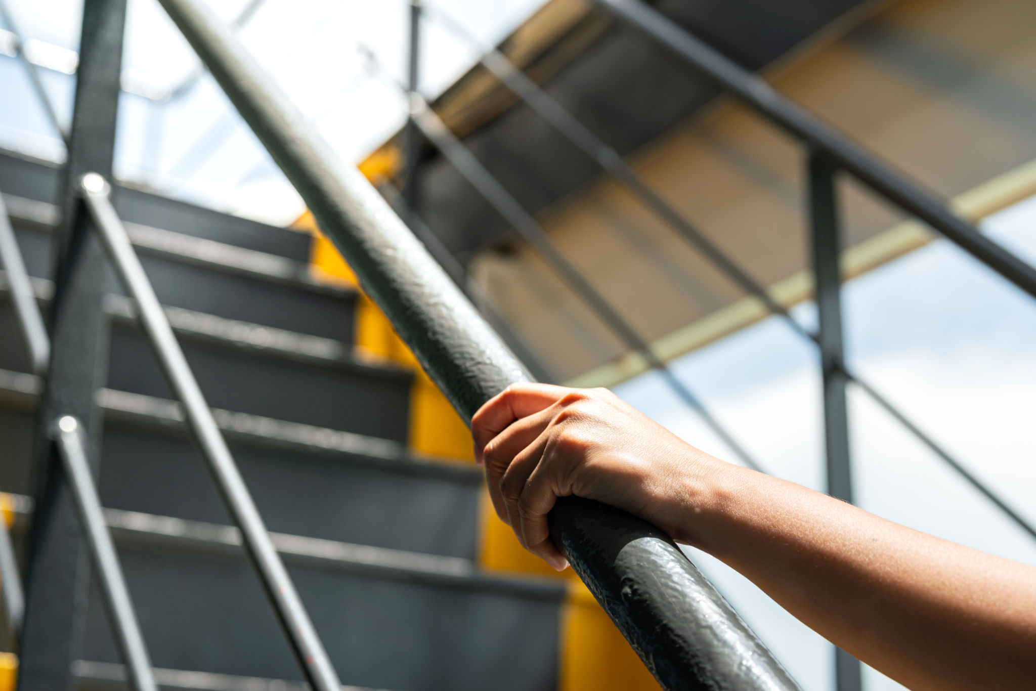 Holding the handrail banister during walking up. Holding the handrail banister during walking up.