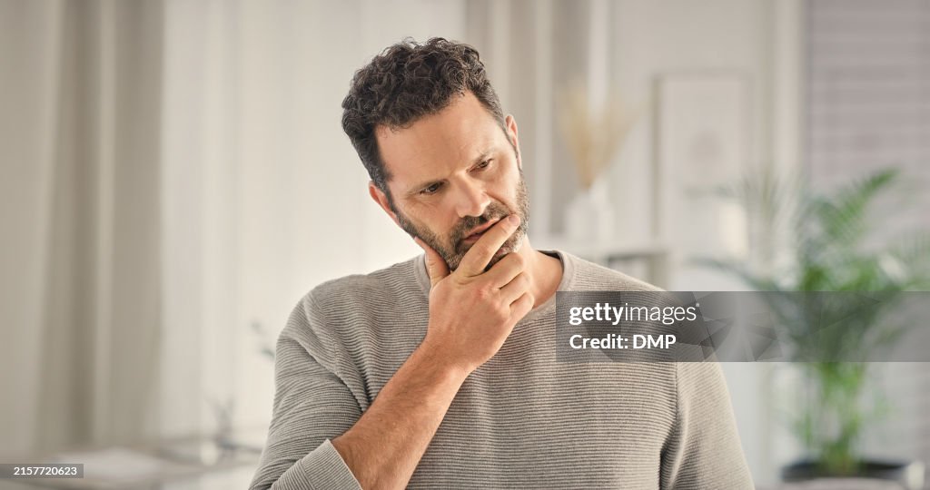 Home, doubt and man with stress, thinking and morning with depression, tired and brain fog. Apartment, burnout and person with anxiety, confused and fatigue with mental health and exhausted in lounge