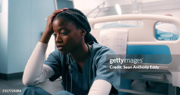 sad nurse, healthcare and woman on floor by anxiety, surgery fail and patient loss while in emergency room. medical care, mental health and professional worker with depression in hospital or clinic - hopelessness stock pictures, royalty-free photos & images