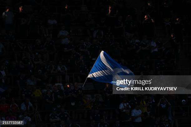 Scottish supporter waves the flag of Scotland ahead of the UEFA Euro 2024 Group A football match between Scotland and Switzerland at the Cologne...