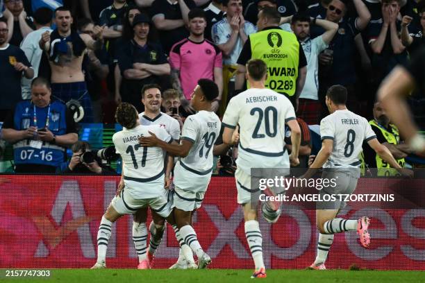 Switzerland's midfielder Xherdan Shaqiri celebrates with teammates after scoring his team's first goal during the UEFA Euro 2024 Group A football...
