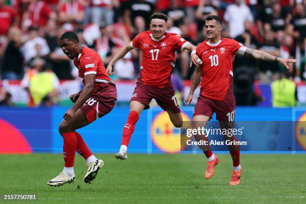 Kwadwo Duah of Switzerland celebrates scoring his team's first goal with teammates Ruben Vargas and Granit Xhaka following a VAR review during the...