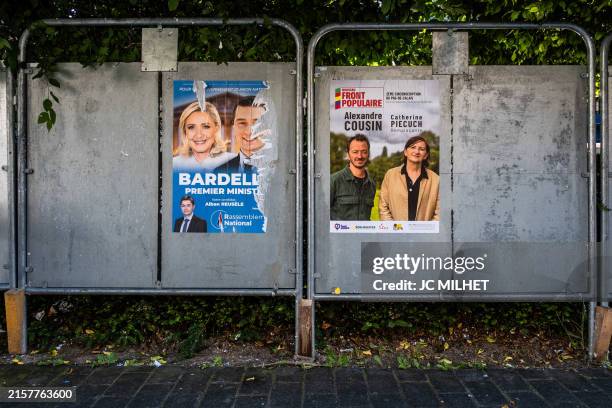 Posters of the Rassemblement National candidate with photos of Marine Le Pen and Jordan Bardella as well as Front Populaire candidates on an...