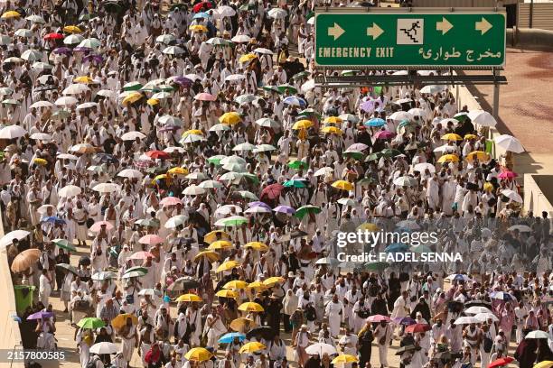 Muslim pilgrim arrive to perform the symbolic 'stoning of the devil' ritual during the annual hajj pilgrimage in Mina on June 16, 2024. Friends and...