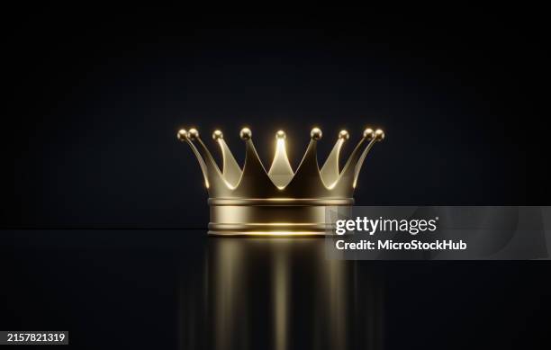 gold colored crown on black background - giuramento foto e immagini stock