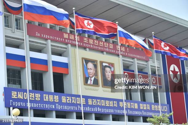 General view shows portraits of Russian President Vladimir Putin and North Korea's leader Kim Jong Un with banners that translate as "Long live the...