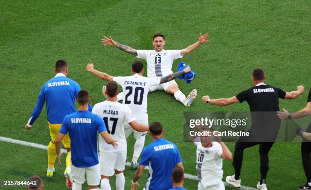 Erik Janza of Slovenia celebrates scoring his team's first goal with teammates during the UEFA EURO 2024 group stage match between Slovenia and...