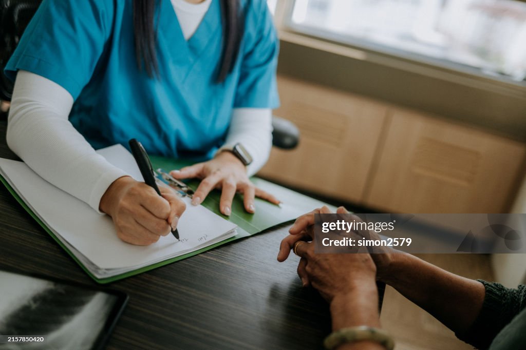 Female doctor writing a medical prescription