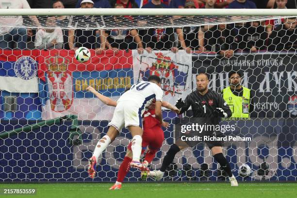 Jude Bellingham of England scores his team's first goal with a header whilst under pressure from Andrija Zivkovic of Serbia as Predrag Rajkovic of...