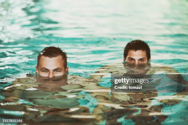 two man half face submerged underwater - half full stock pictures, royalty-free photos & images
