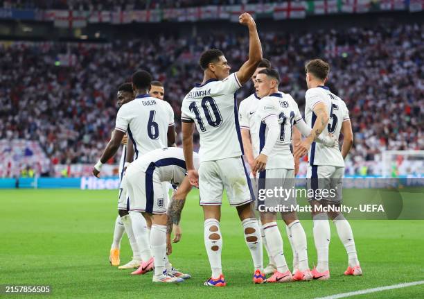 Jude Bellingham of England celebrates with teammates after scoring his team's first goal during the UEFA EURO 2024 group stage match between Serbia...