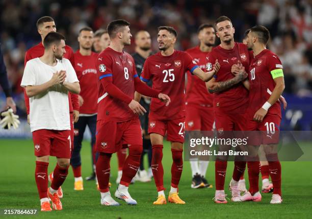 Luka Jovic of Serbia reacts as he speaks with teammate Filip Mladenovic as players of Serbia acknowledge the fans after the UEFA EURO 2024 group...